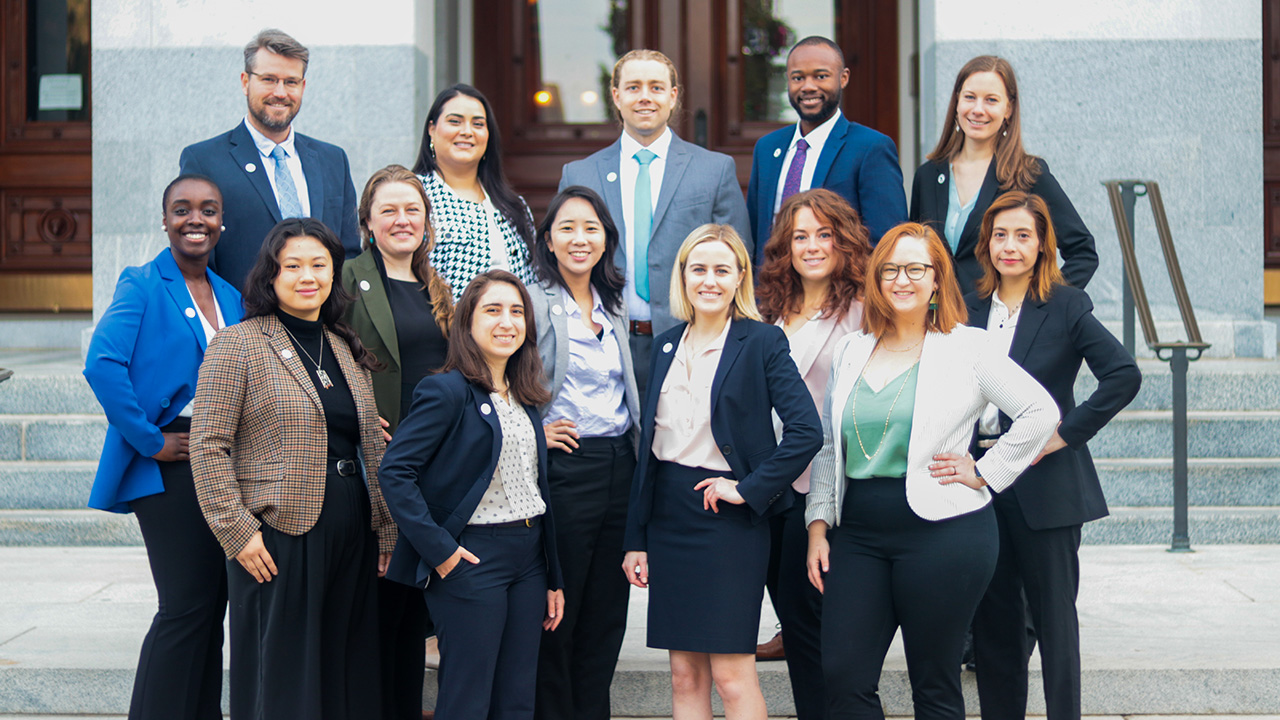 A group photo of the 2023 CCST S&T Policy Fellows standing together in front of the California State Capitol steps dressed in business attire.