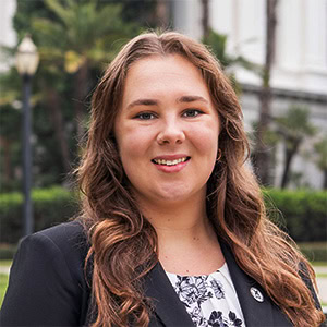 Professional headshot in front of the California State Capitol.