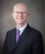 A professional headshot of the Board member.