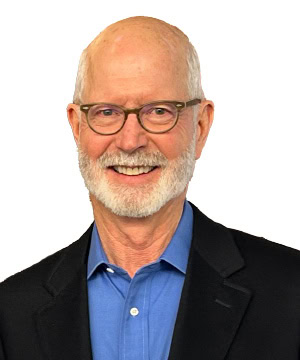 A headshot of Bruce in a black blazer and blue collared shirt.
