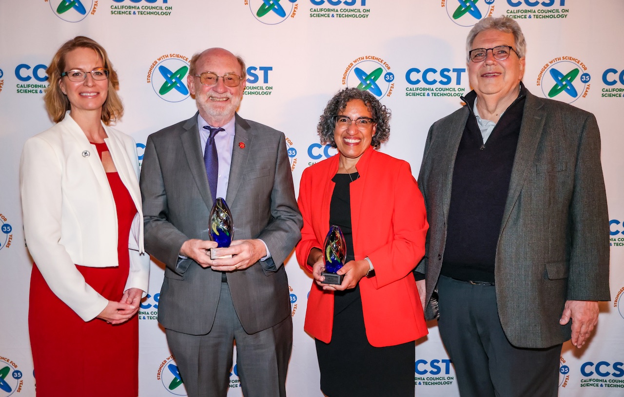 Awardees and CCST leadership standing in front of a CCST Step and Repeat with CCST's logo dressed in formal wear and holding their awards.