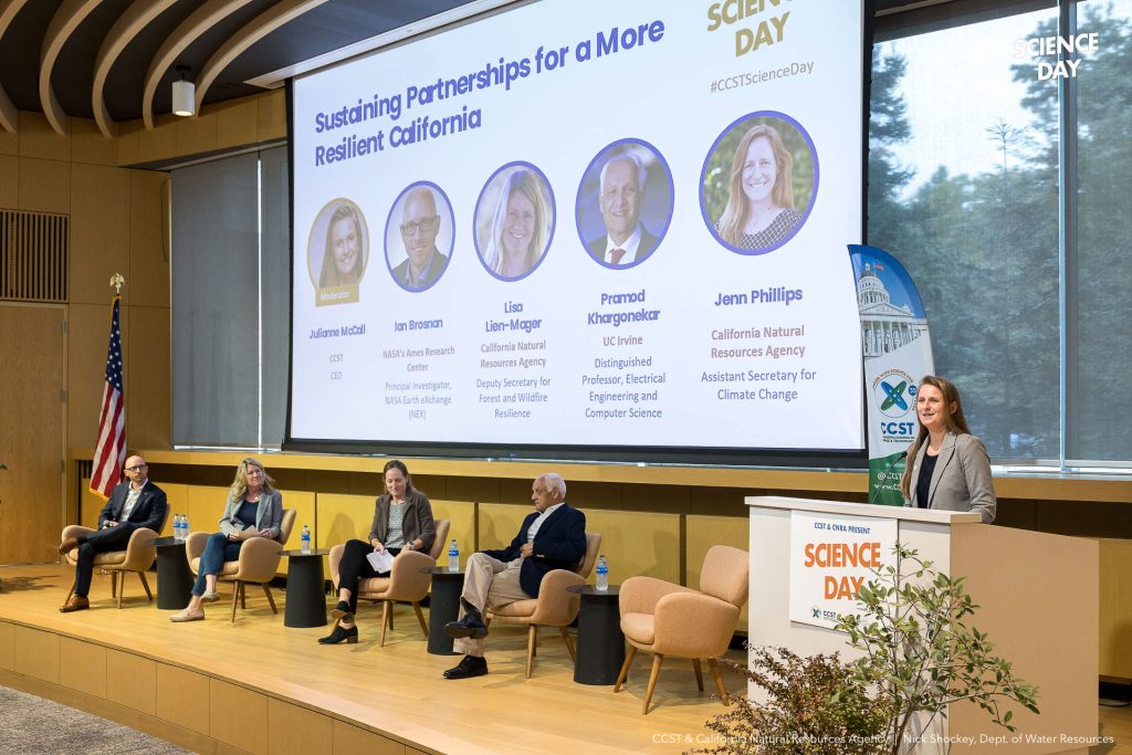 Julianne opens the panel discussion on stage