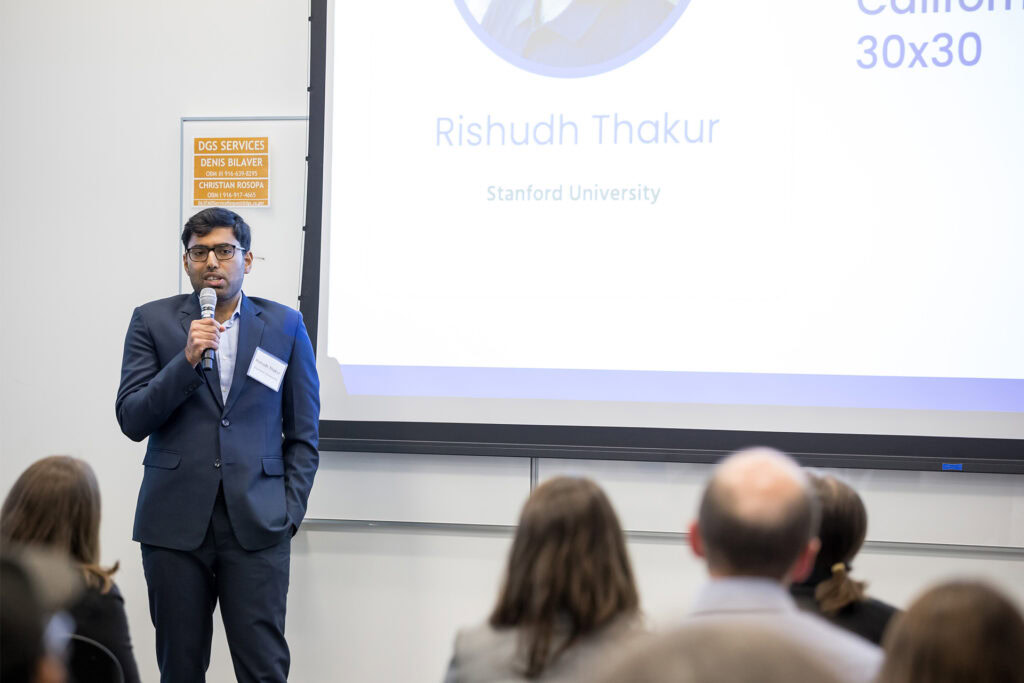 Man in suit presenting at Science Day 2026 event.