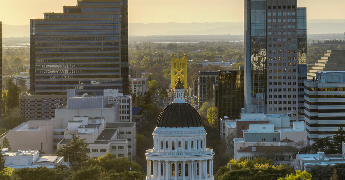 An aerial view of the California State Capitol toward Tower Bridge. By Leo on Unsplash.