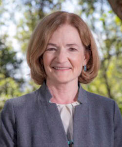 A professional headshot of the Board member outside.