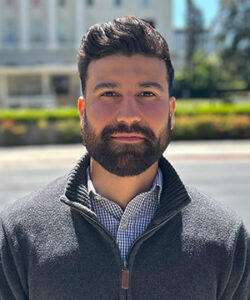 Headshot of Ceasar in front of the California State Capitol