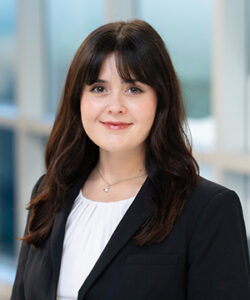 Professional headshot of Christina in a blakc blazer and white blouse.
