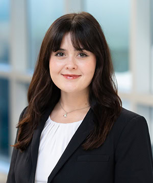 Professional headshot of Christina in a blakc blazer and white blouse.