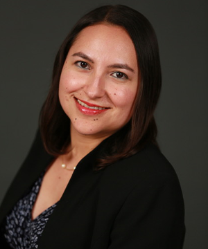 A professional headshot of the Board member.