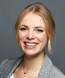 Henriette Canino in a gray business blazer.
