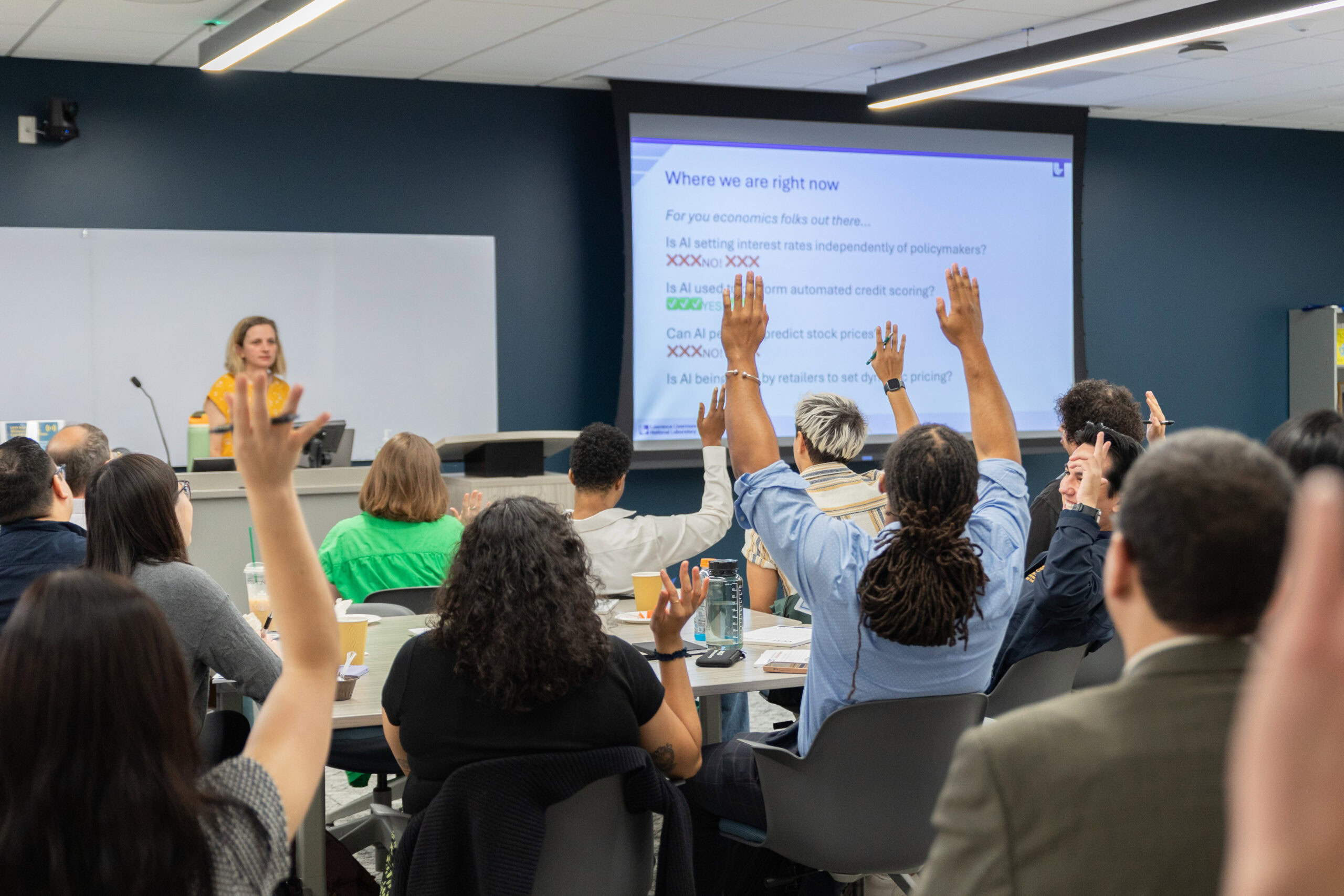 A presentation on AI from the audience perspective with hands raised