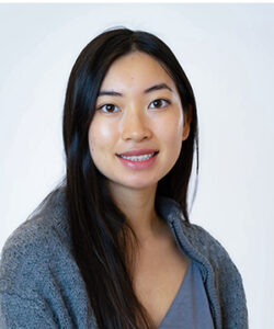 Professional headshot of Jenna in a grey sweater.