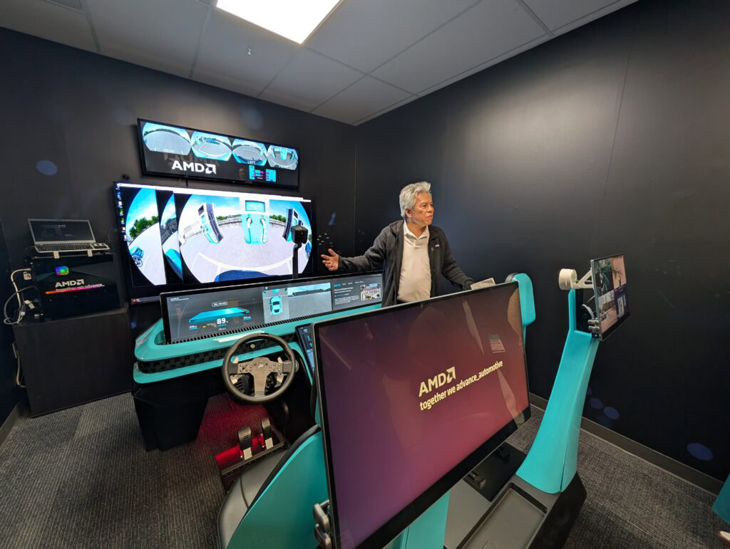 AMD staff demonstrating AMD self driving car technology in their showroom.
