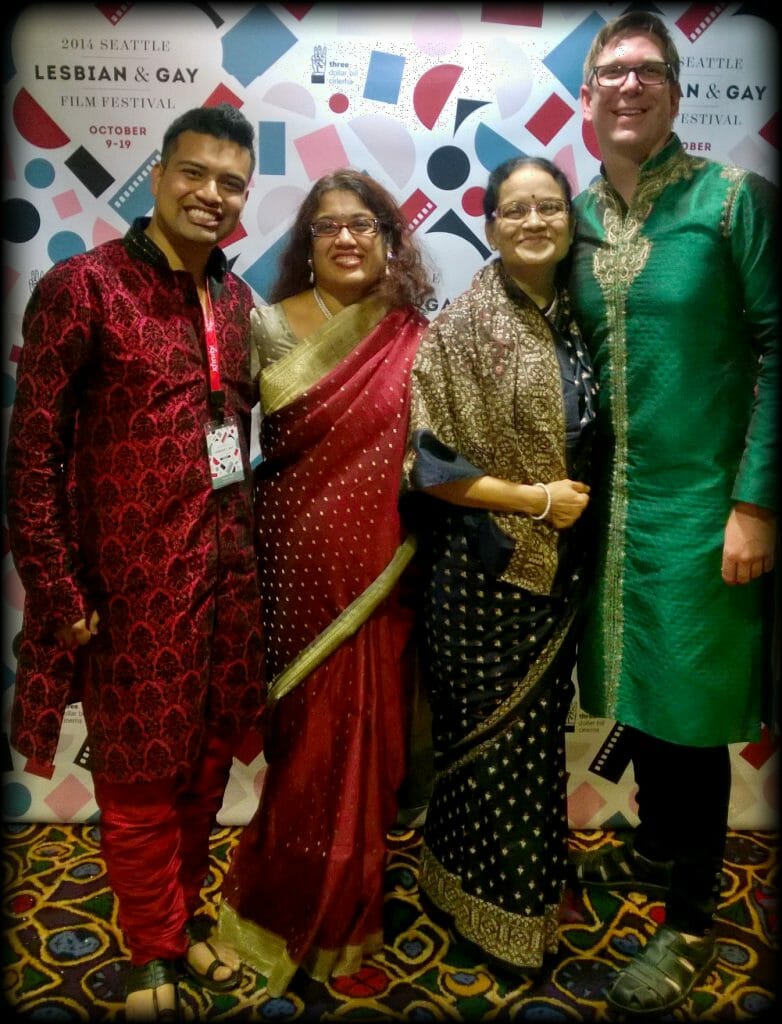 Bish Paul, PhD, a 2017 CCST Science & Technology Policy Fellow, with his family at the 2014 Seattle Lesbian & Gay Film Festival. Bish, his sister, mother, and partner are all festooned in traditional Indian sherwanis and saris in red, gold, and greens.