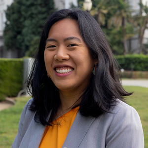 A formal headshot in front of the California State Capitol.