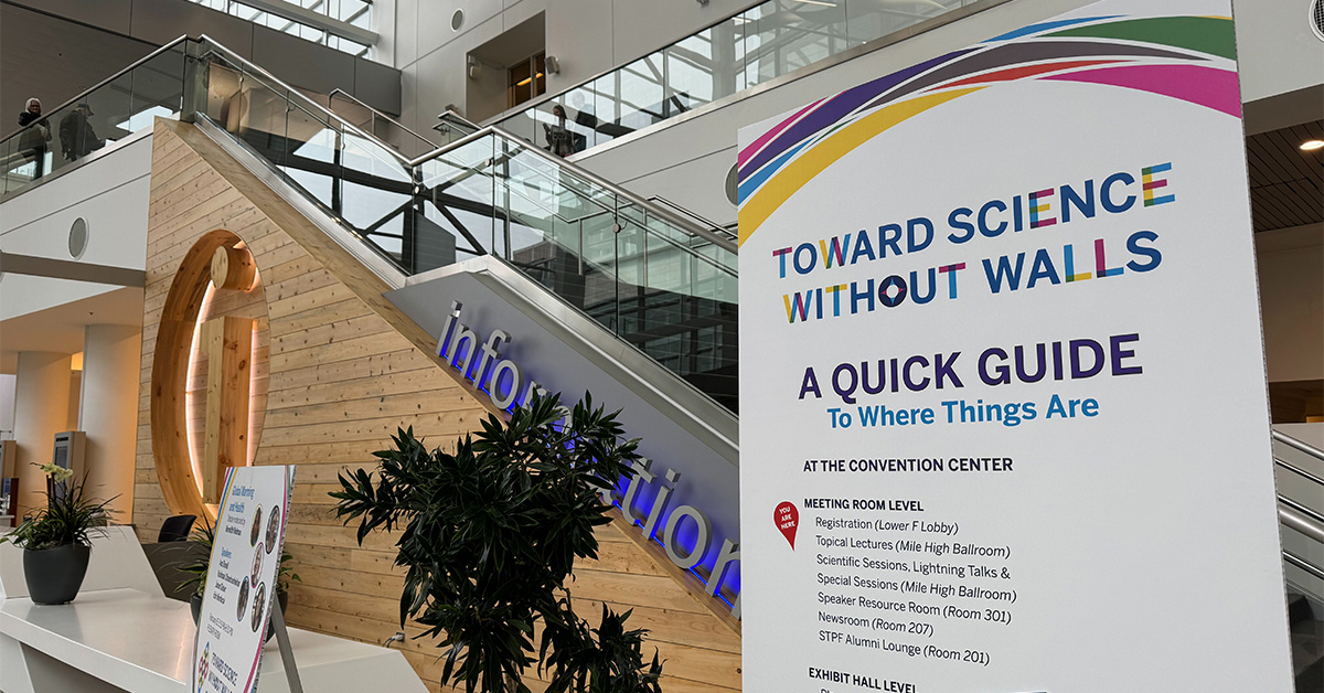 A photo from inside the convention center showing a pop up banner with the conference theme, "Toward science without walls."