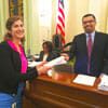 Science Fellow handing documents to legislator