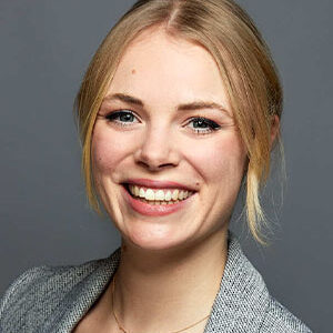 Henriette Canino in a gray business blazer.