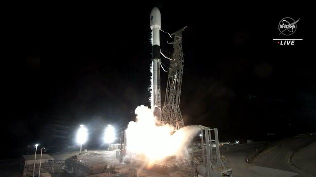 A screenshot of the NASA SWOT satellite launching into space with the NASA logo and "LIVE" text in white on a black background.